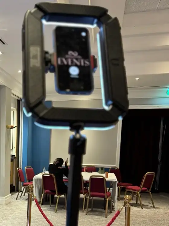 360 video booth camera arm with ring light holding a phone